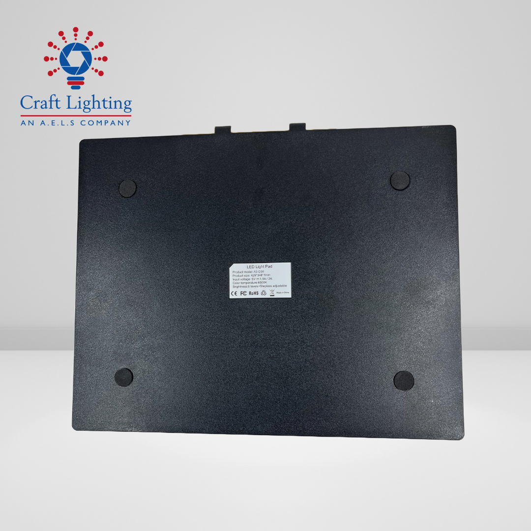 A black metal plate with a white sticker on it, showcasing an A3 LIGHT BOARD.